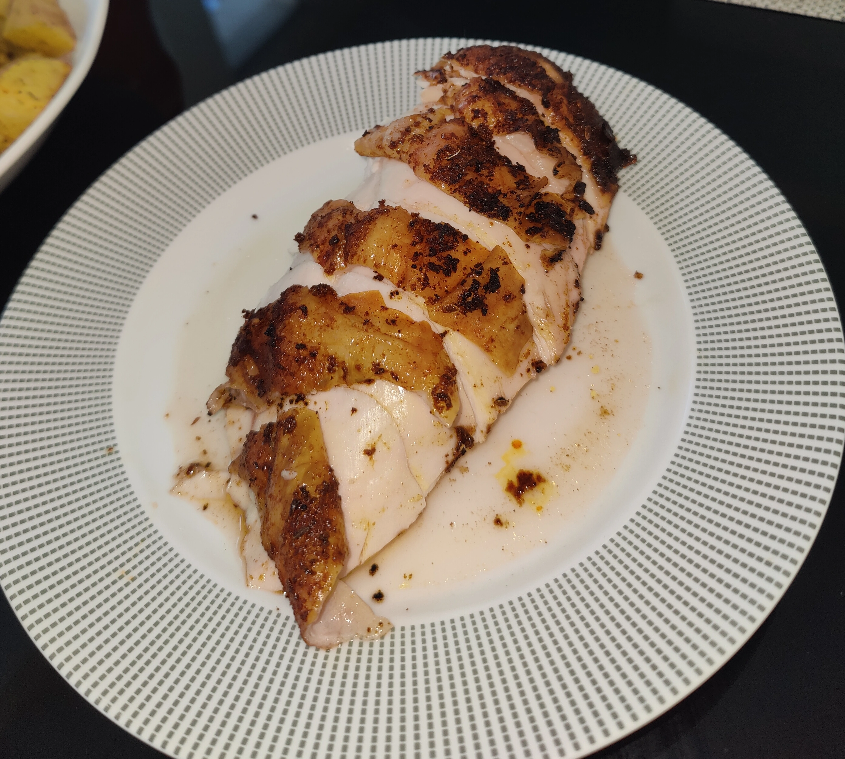 image of a sliced smoked chicken breast with crispy skin