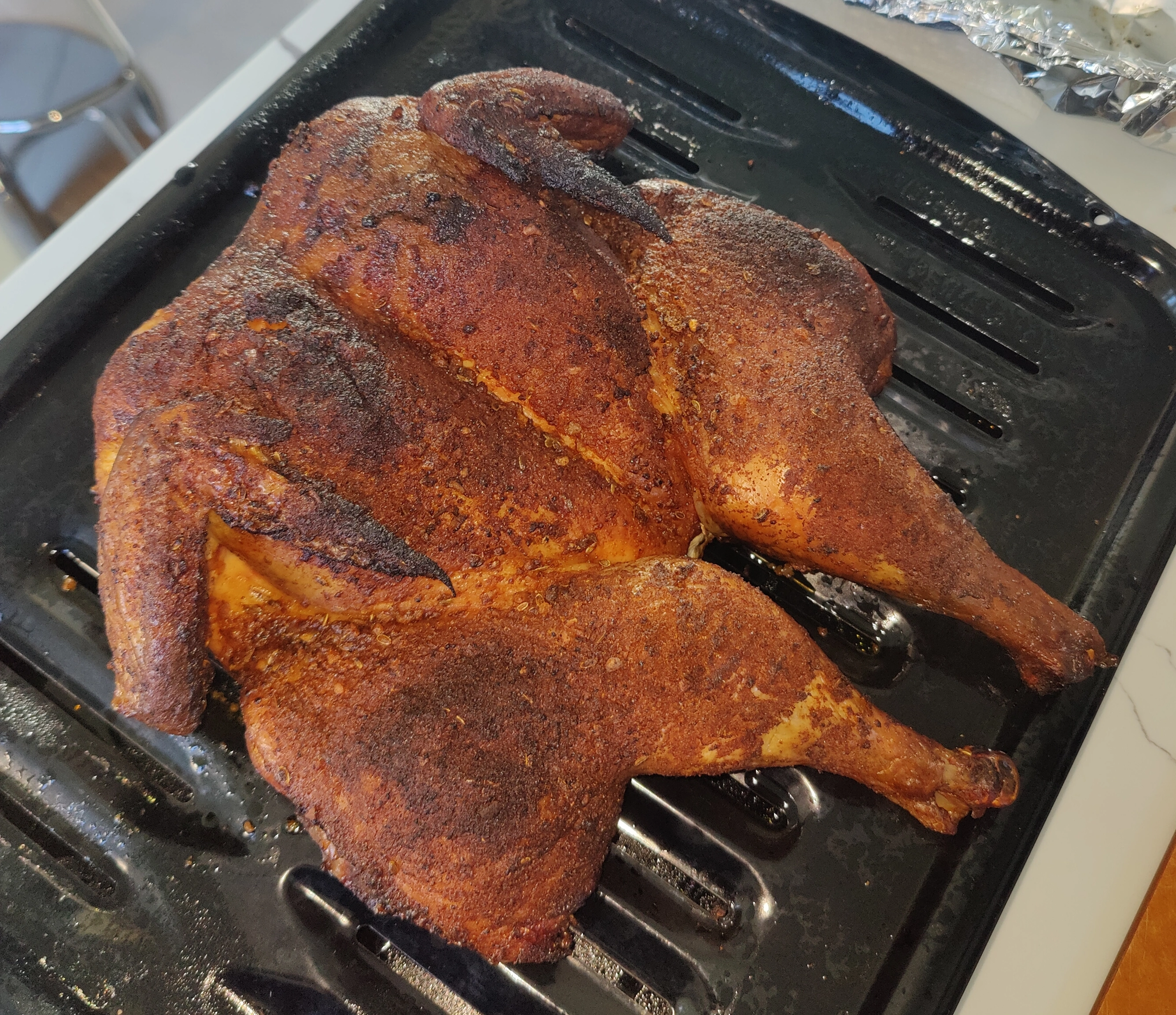image of a spatchcocked smoked chicken with BBQ rub