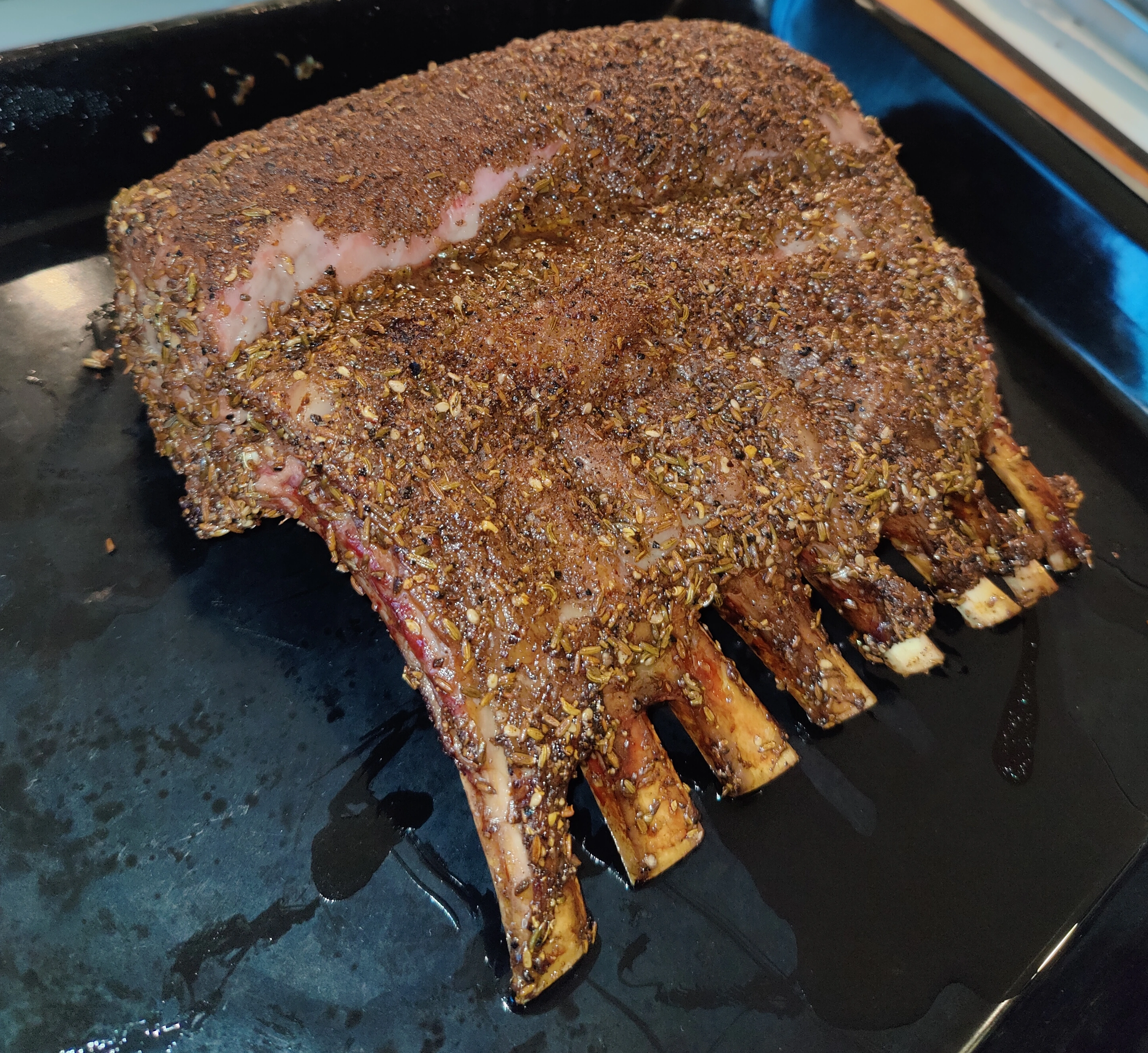image showing a smoked lamb rack from the other side with cumin rub